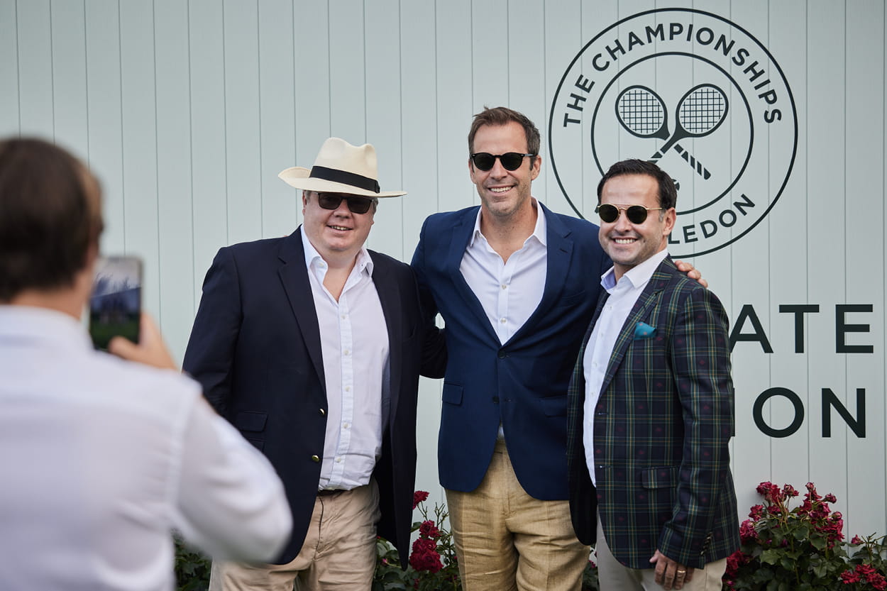 Former tennis player Greg Rusedski smiling for a photograph with hospitality guests in Rosewater Pavilion at Wimbledon