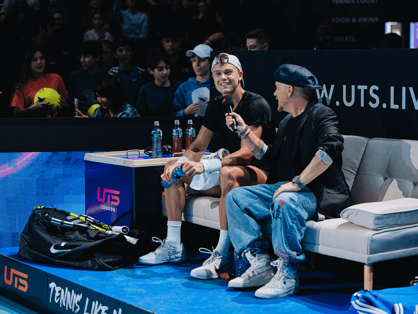 Tennis player Holger Rune talking while sitting during the court-side player and coach interview at the 2023 UTS Grand Final in London