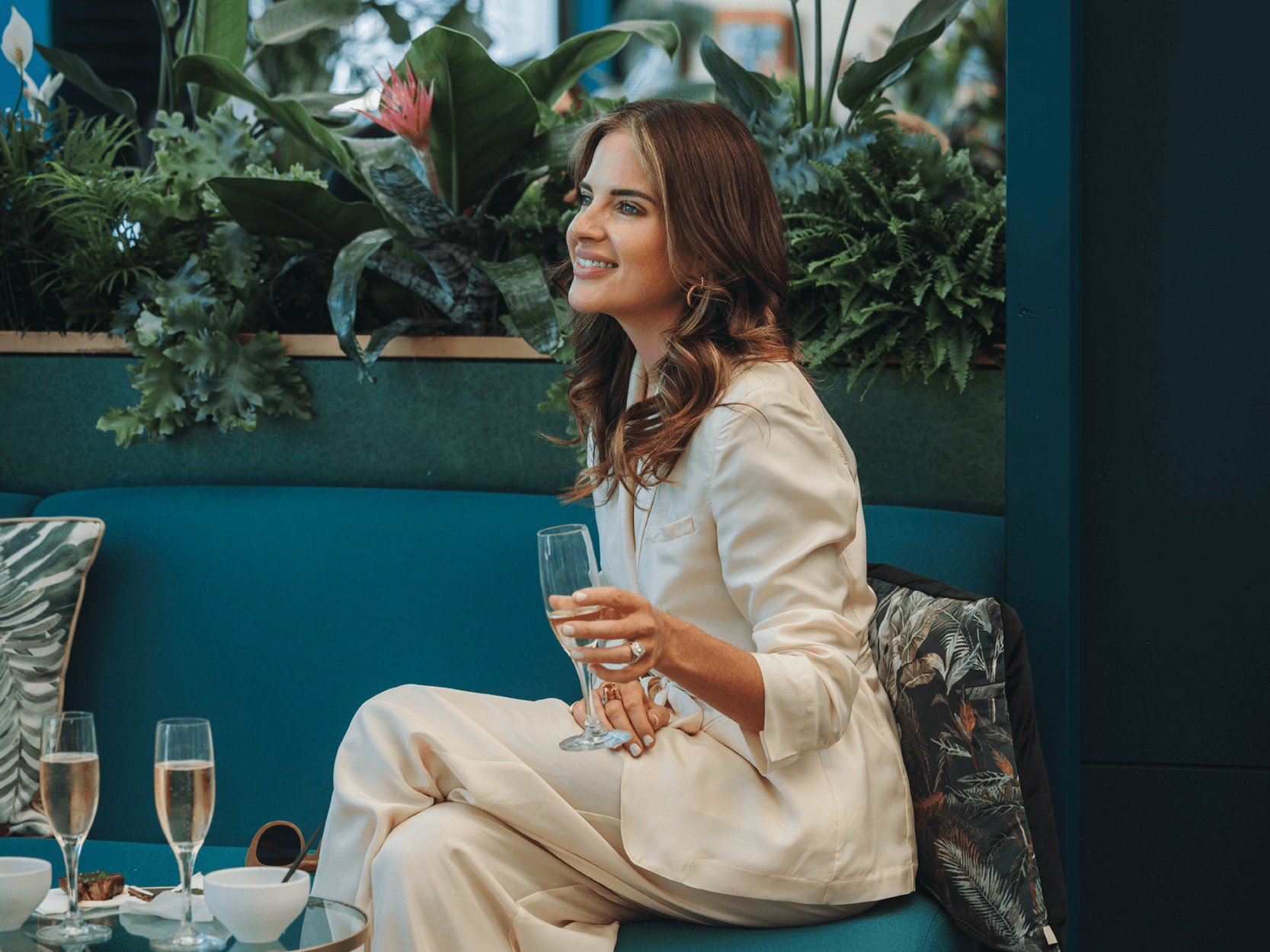 Former Made in Chelsea reality tv star Binky Felstead sat inside The Treehouse smiling with a glass of Champagne at Wimbledon for the tennis