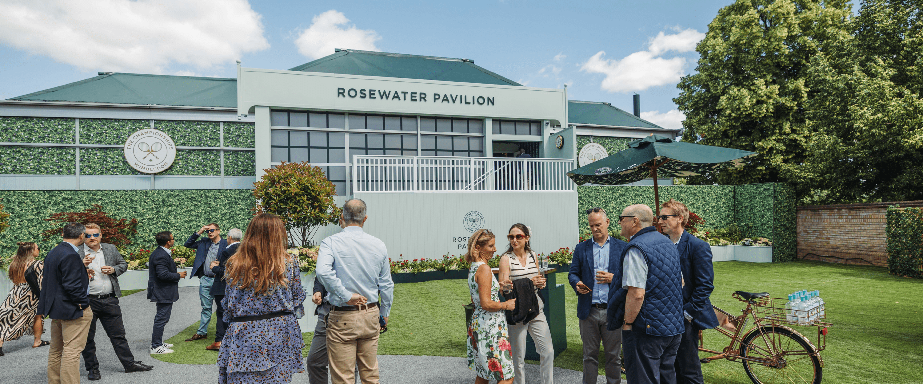 Front garden area at Rosewater Pavilion with guests chatting and enjoying a drink at The Championships Wimbledon in 2024