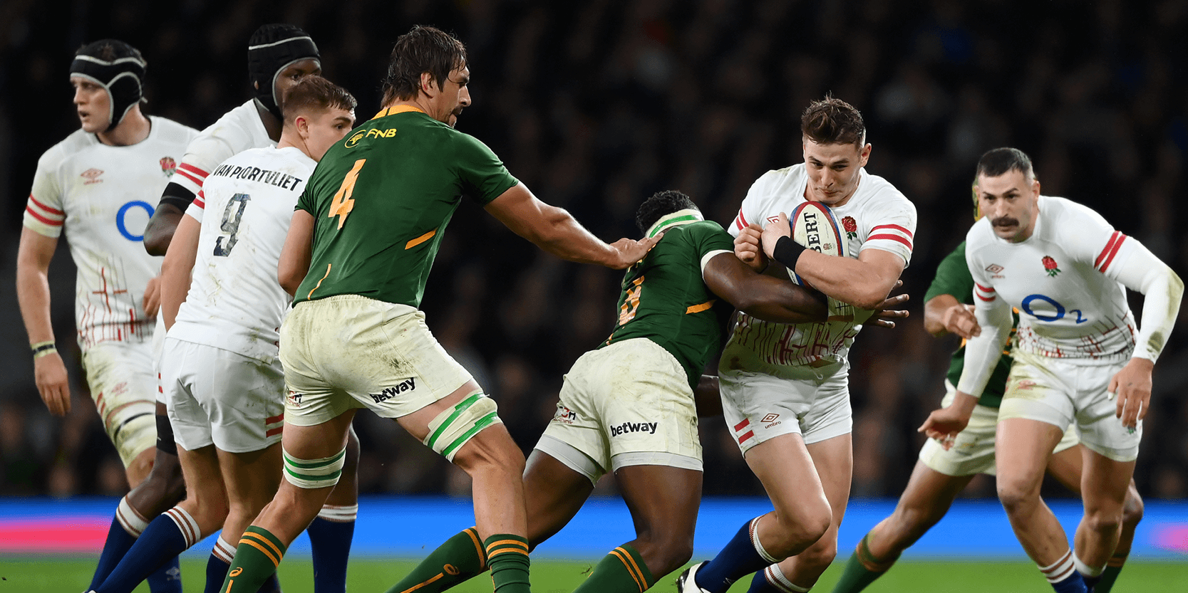 England rugby player Freddie Steward running with the ball against South Africa during a match at Twickenham Stadium