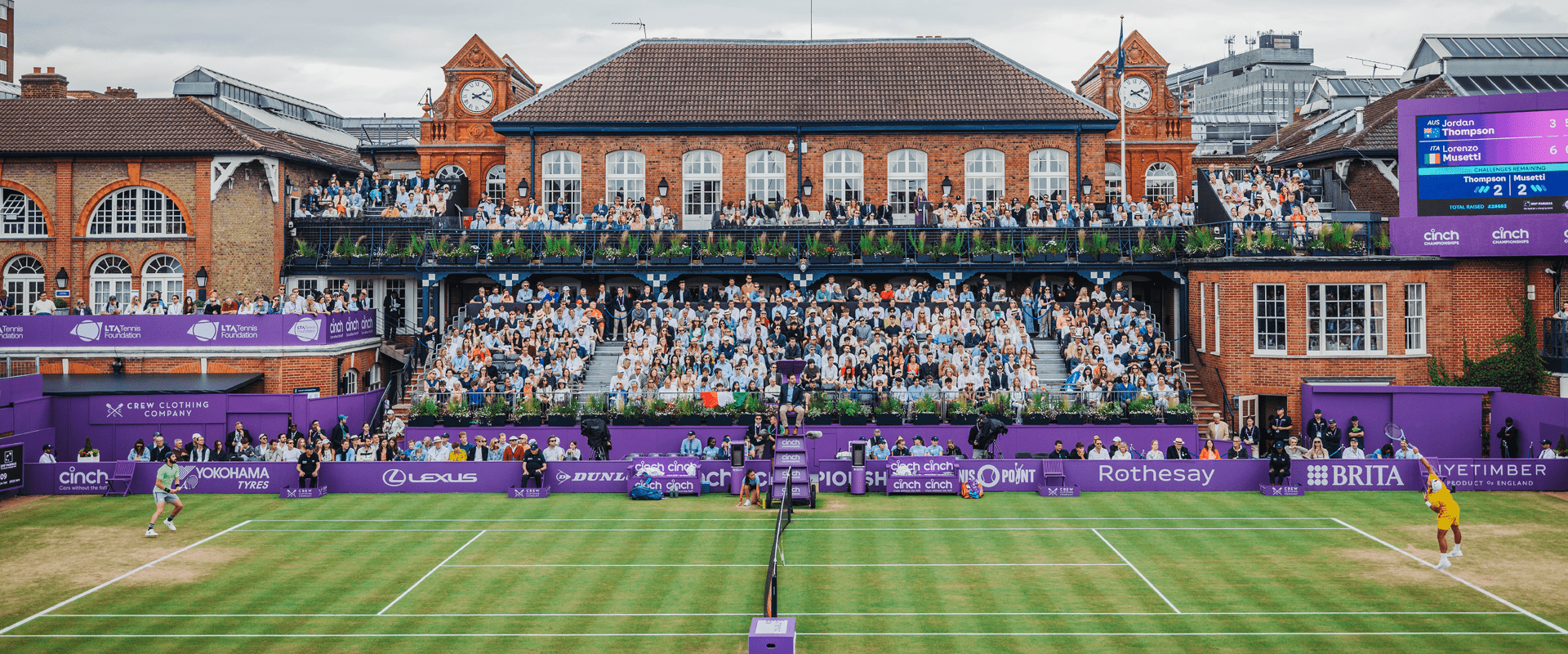 The view of The Queen's Club Clubhouse and Centre Court with players on during the semi-final