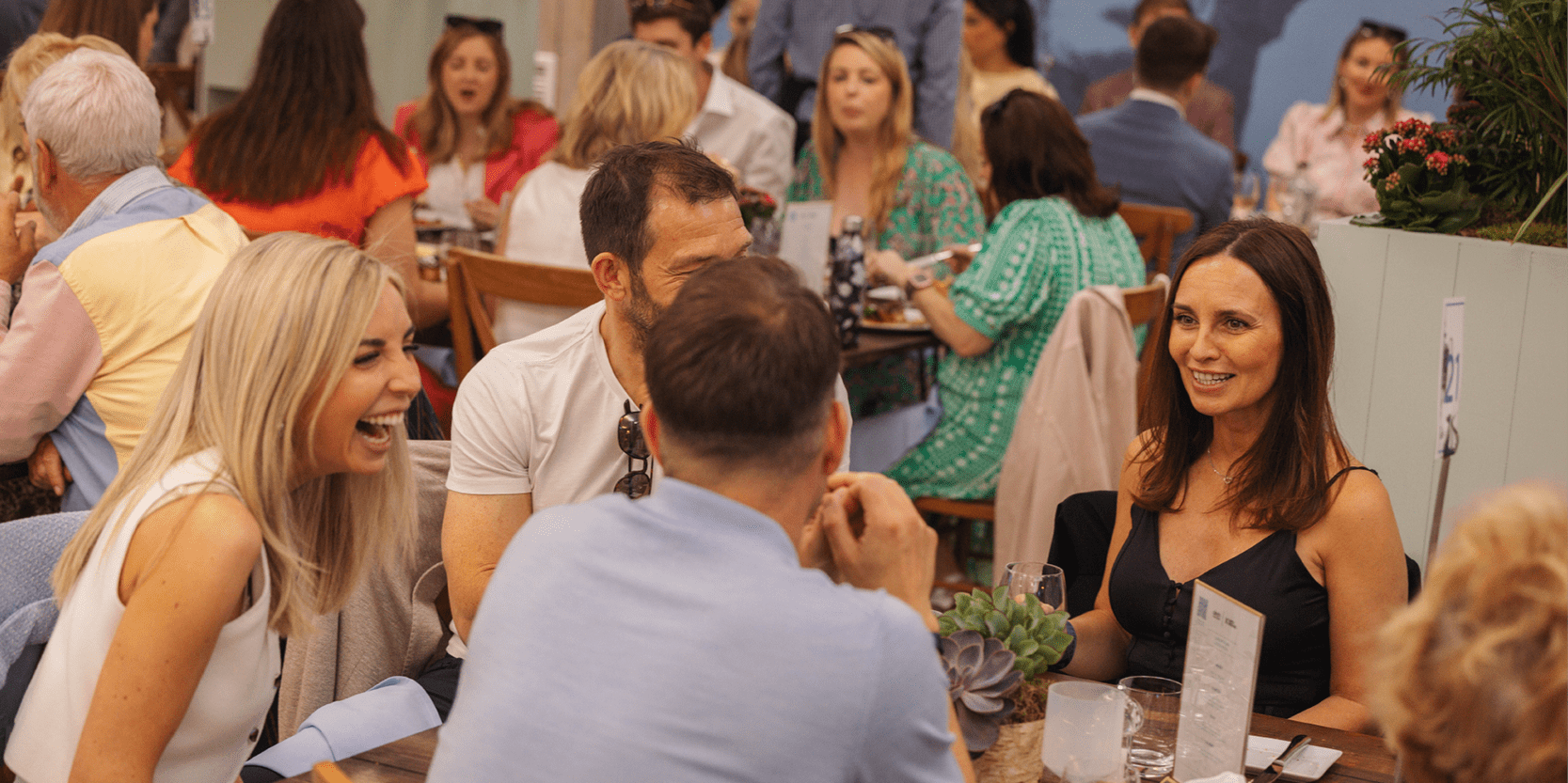 Guests chatting at their table in hospitality area Love Fifteen at The Queen's Club for the Championships tennis