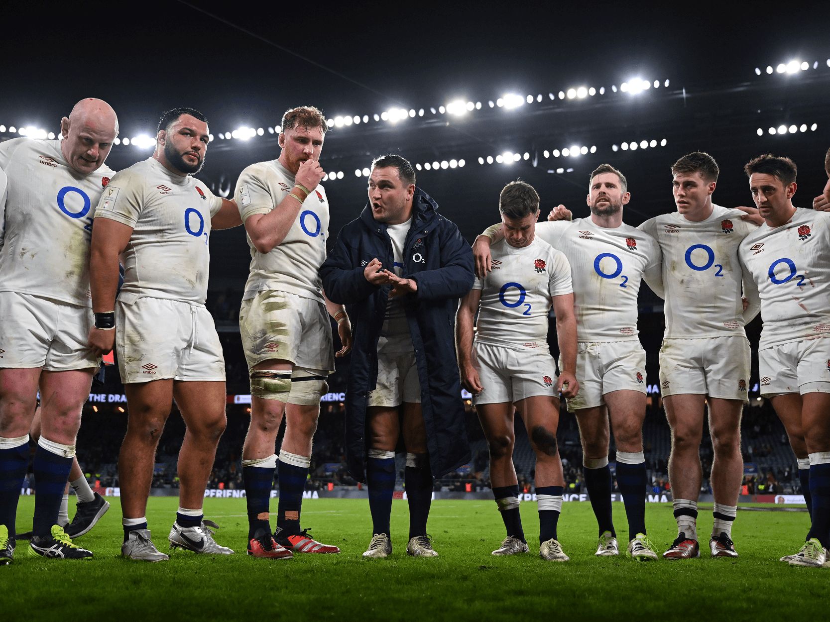 Jamie George England rugby captain giving a team talk to the players gathered round at the end of a rugby match at Twickenham Stadium