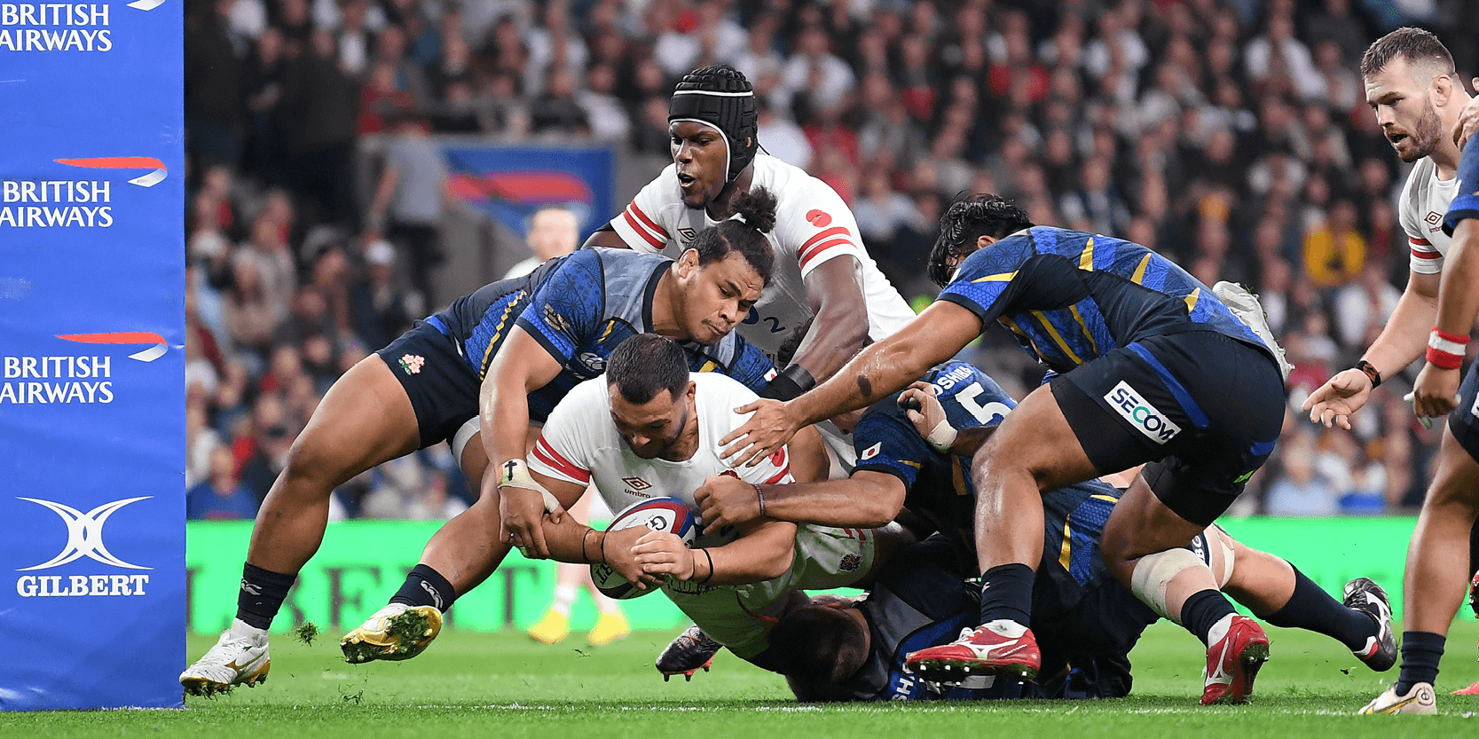 England rugby player Ellis Genge scoring a try with Maro Itoje running behind in a match against Japan