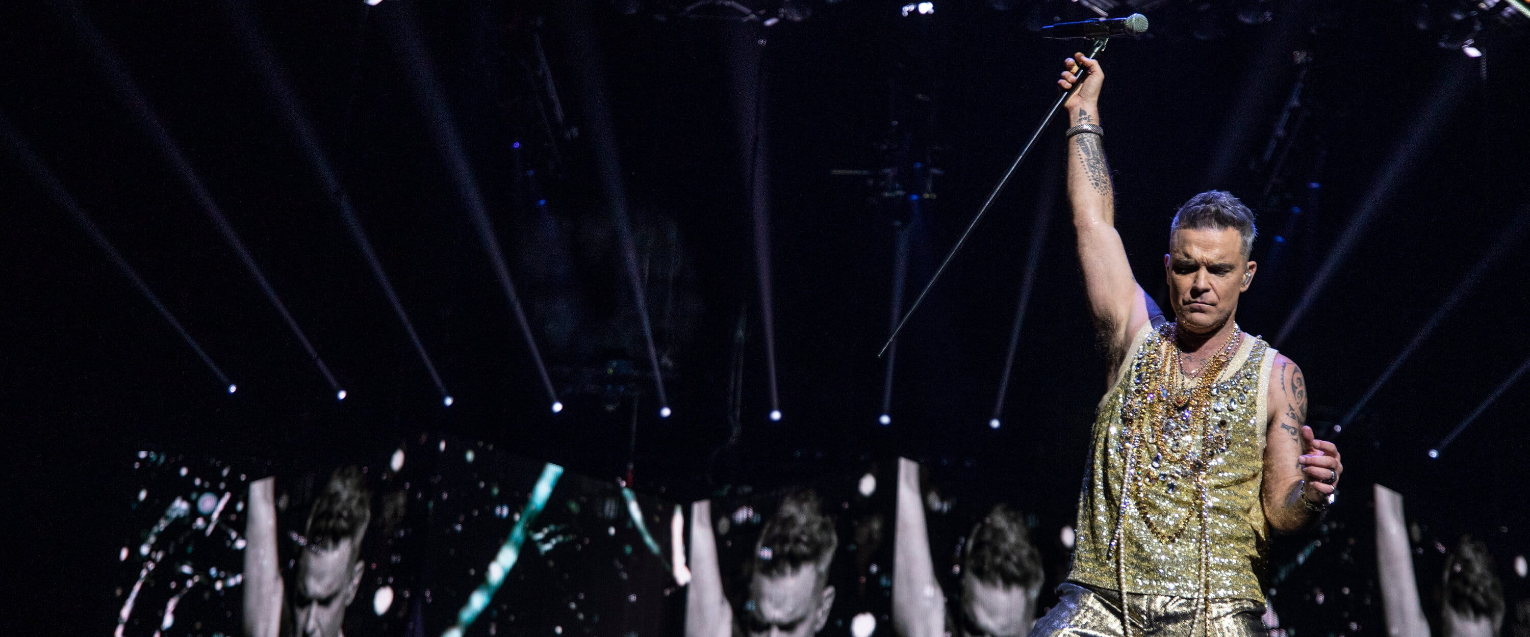 Singer Robbie Williams on stage performing