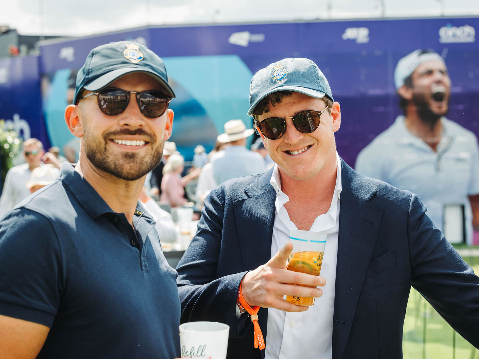 Guests smiling on the terrace at The Queen's Club championships tennis tournament in hospitality 