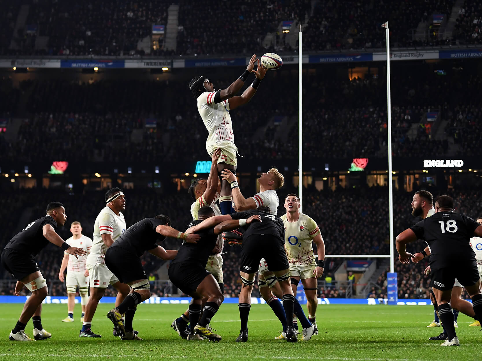Maro Itoje jumping up to catch the ball during a line out in a rugby match between England and New Zealand in the 2022 Autumn Nations Series at Twickenham Stadium
