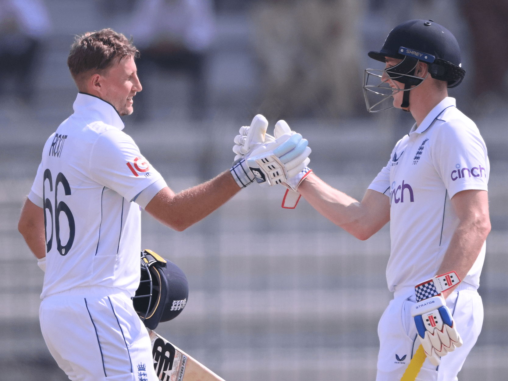 England cricketers Joe Root and Harry Brook fist bumping during a Test match after batting