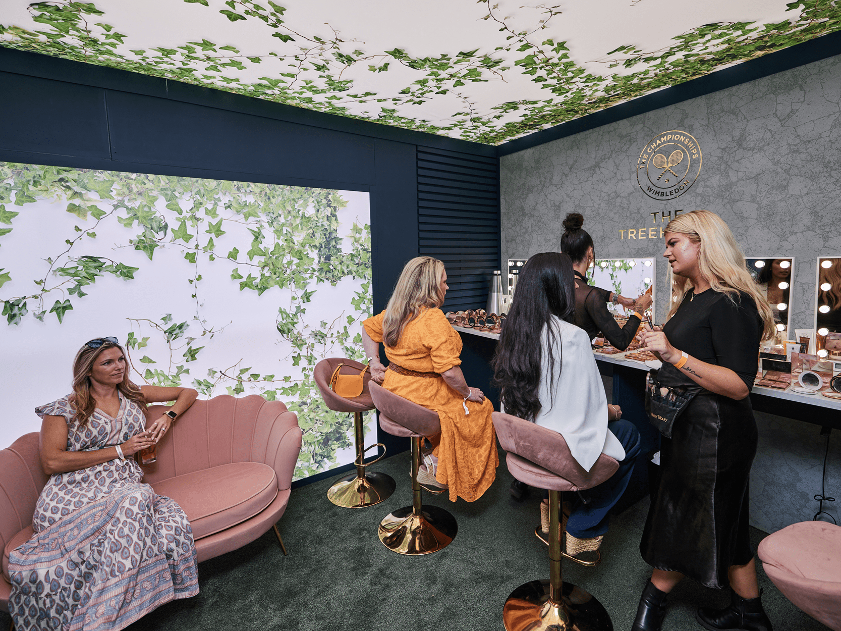 Pamper Room in the Treehouse hospitality experience at Wimbledon tennis with guests enjoying Charlotte Tilbury makeup products