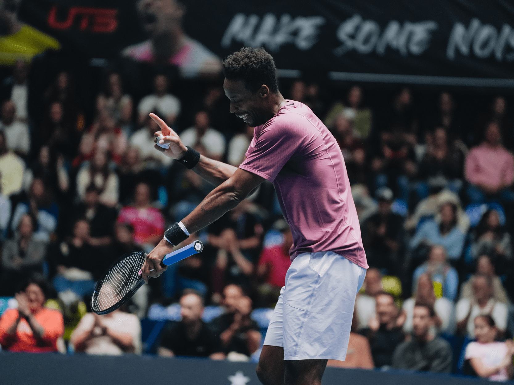 Tennis player Gael Monfils dancing at UTS event in 2024 for the crowd holding his tennis racket