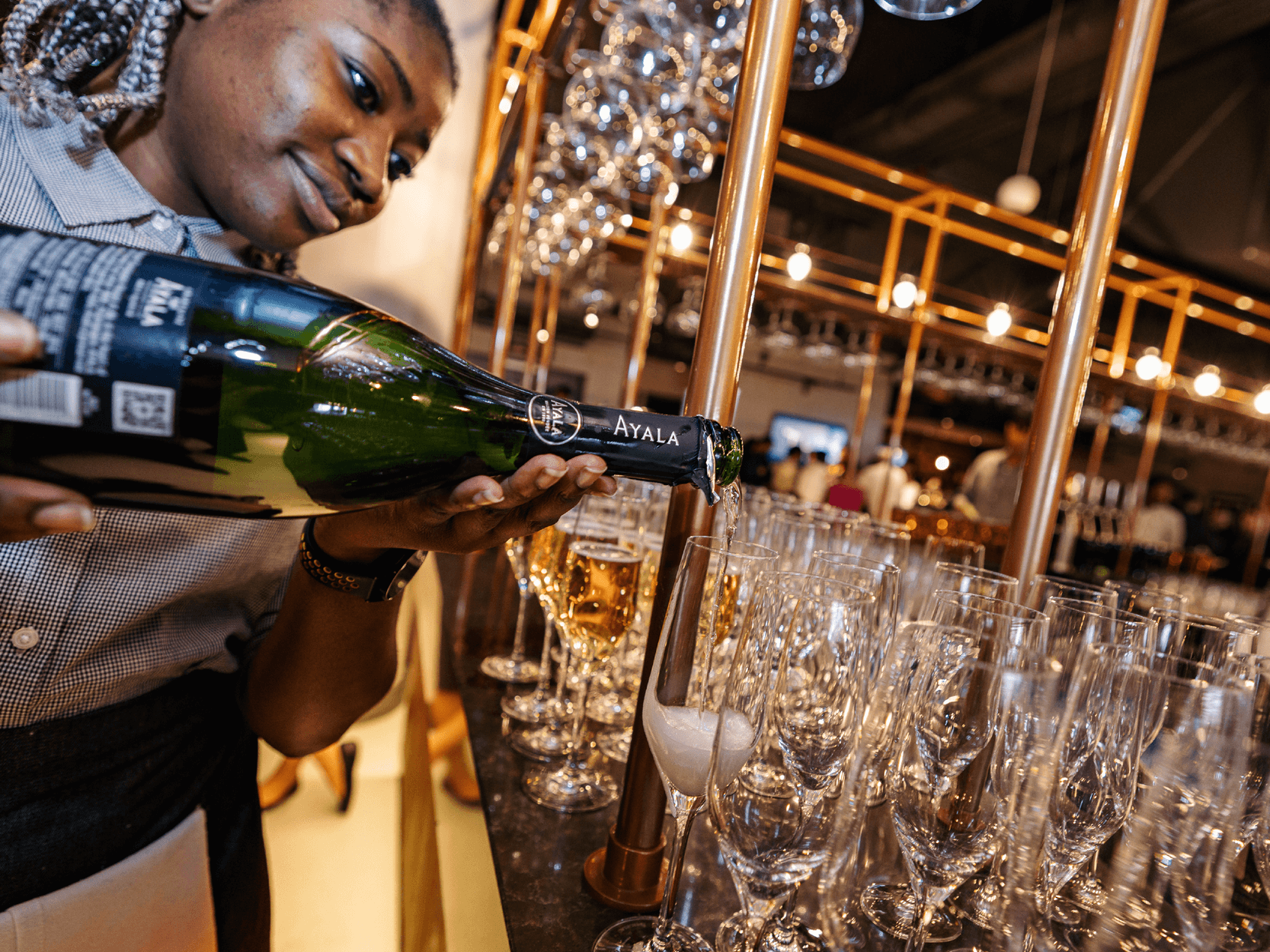 Hostess at the bar in Allianz Stadium Twickenham pouring glasses of Champagne for guests at a rugby match 