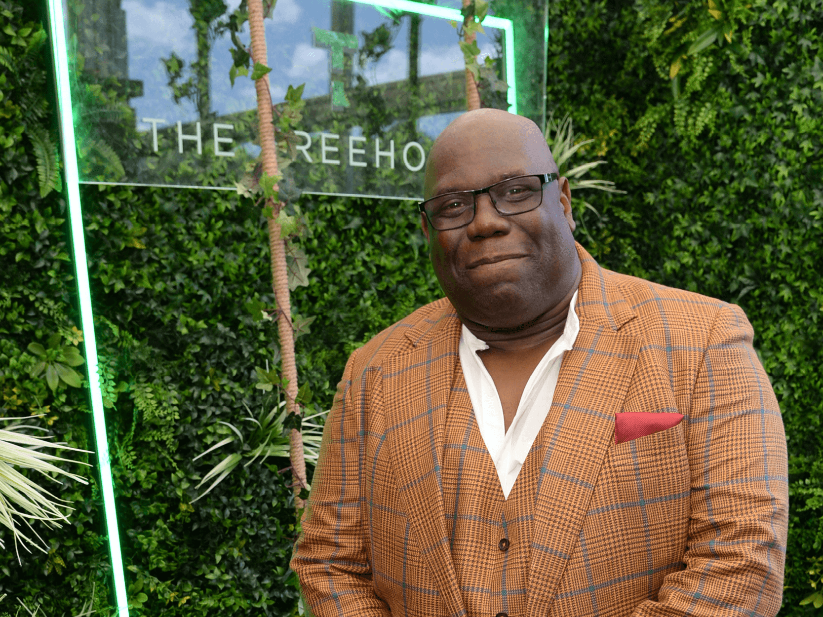 DJ and music producer Carl Cox smiling for a picture in the Treehouse hospitality at Wimbledon with Keith Prowse