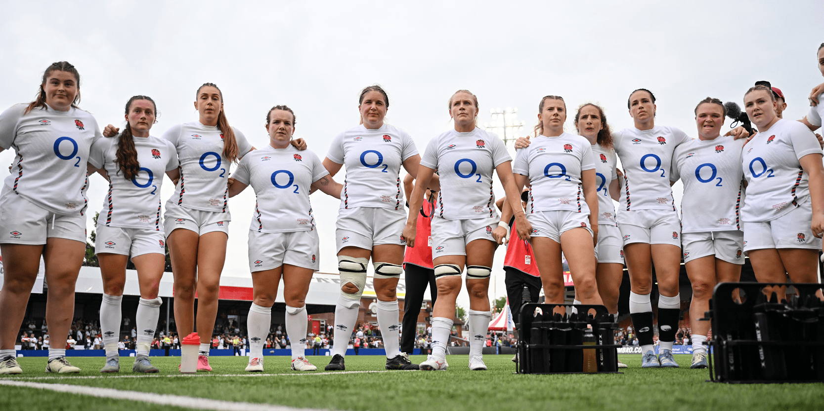 England's Red Roses rugby team lining up in a huddle during a match on the pitch having a team talk