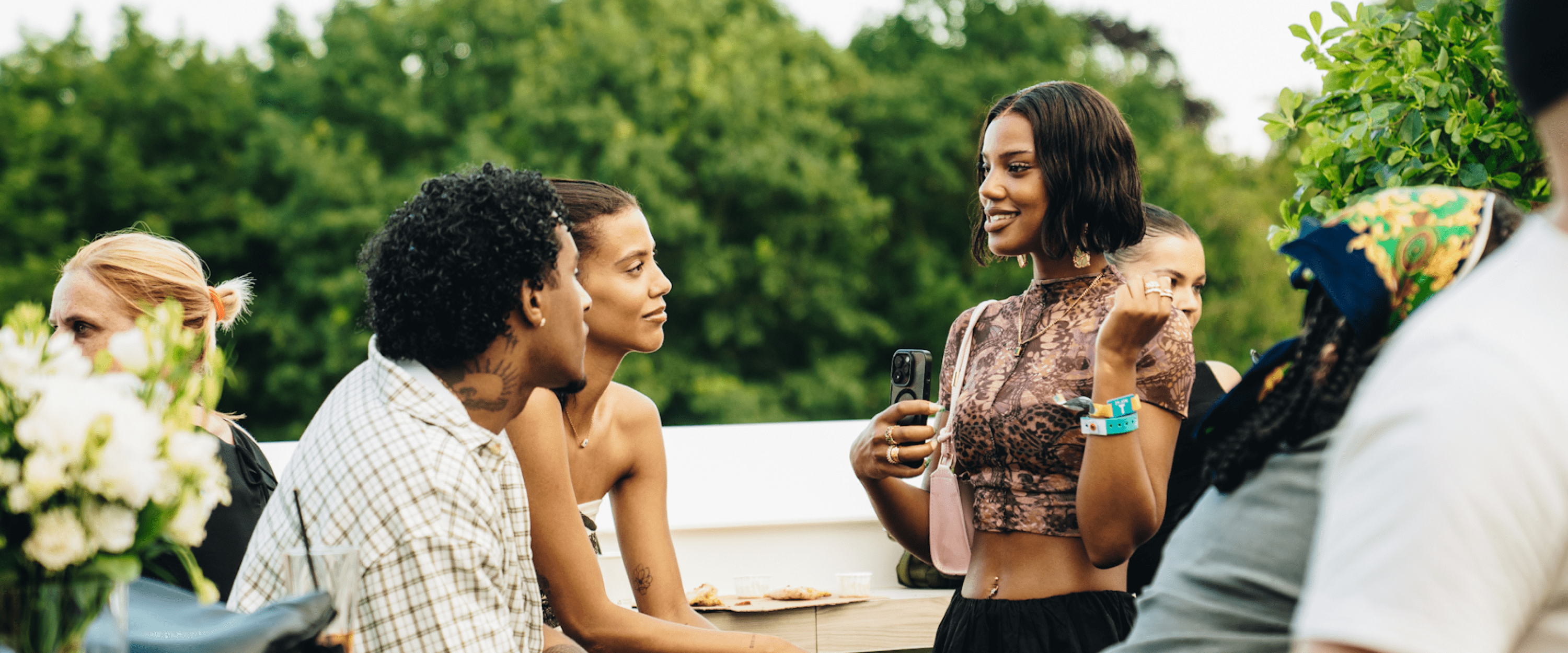 Guests on the Great Oak Roof Garden Terrace chatting and drinking in hospitality for a concert at BST Hyde Park