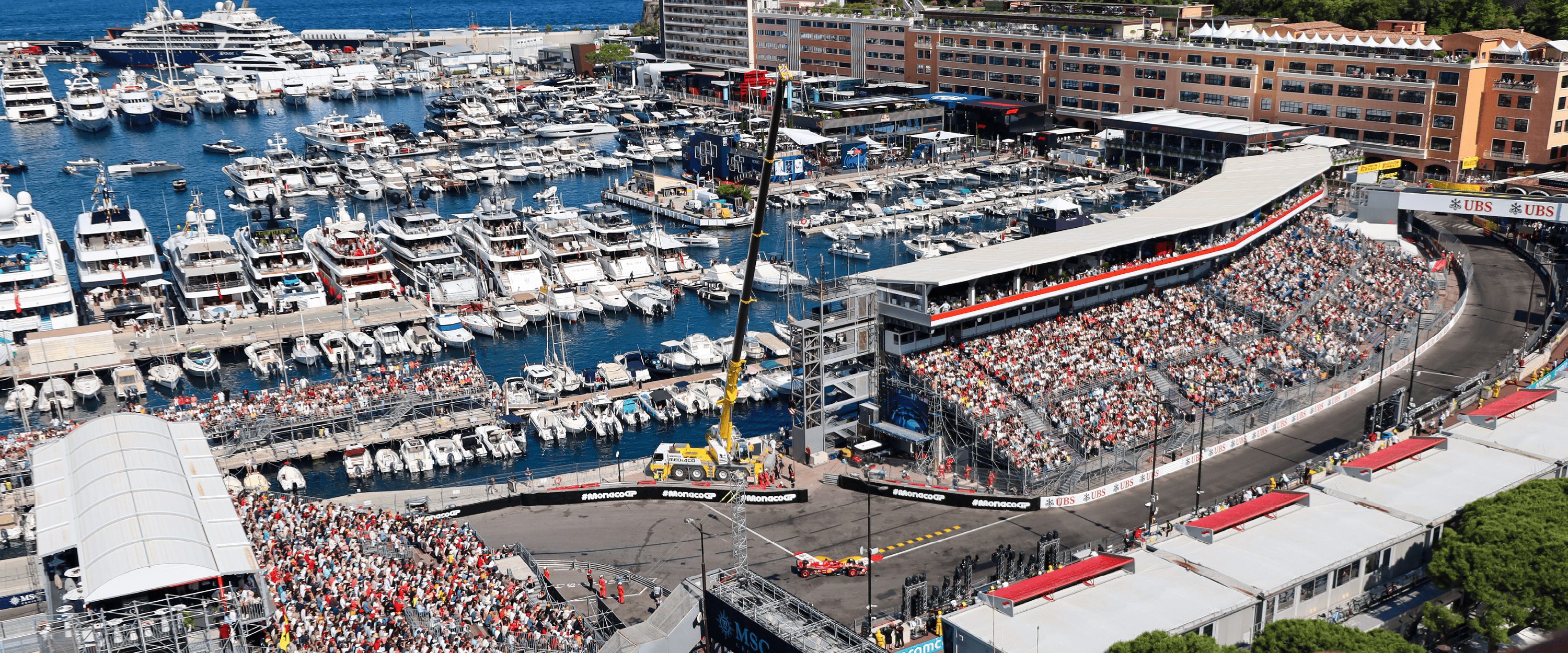 View of the Monaco streets during the Formula One Monaco Grand Prix overlooking the harbour with yachts and fans in the stands