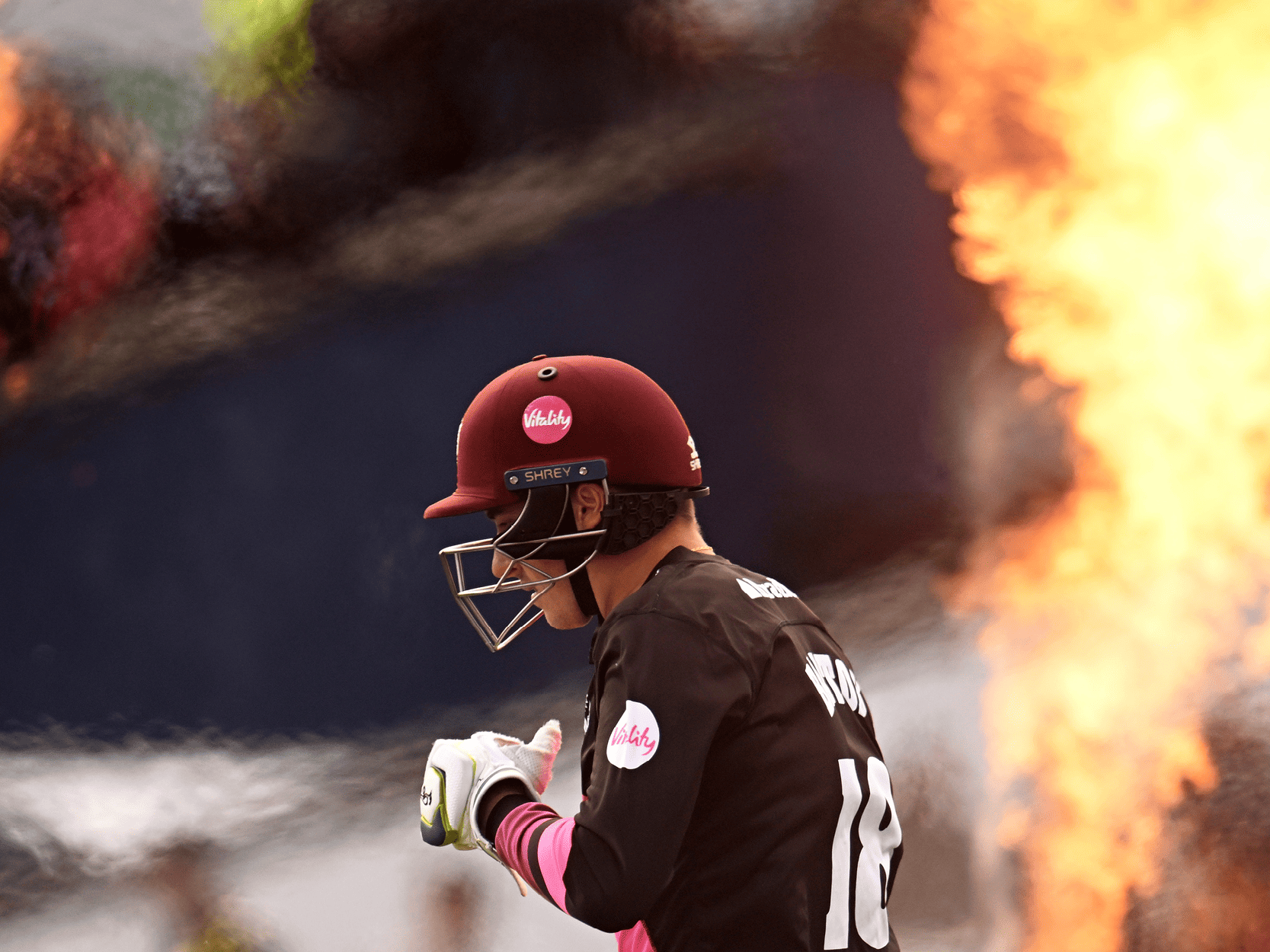 T20 cricket player walking on the pitch with fireworks in the background at Edgbaston during T20 Finals Day