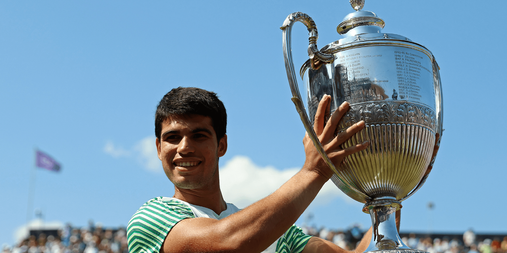 Spanish tennis player Carlos Alcaraz holding the trophy after winning the final at The Queen's Club Championships in 2023