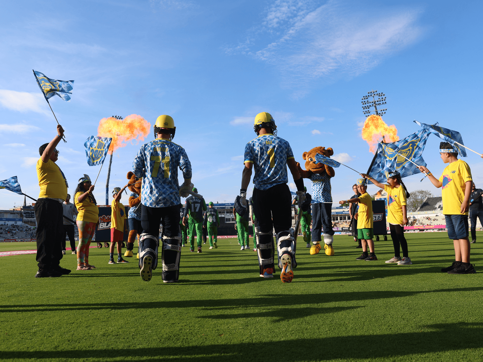 Birmingham Bears players walking onto the cricket pitch for a T20 match at Edgbaston Stadium