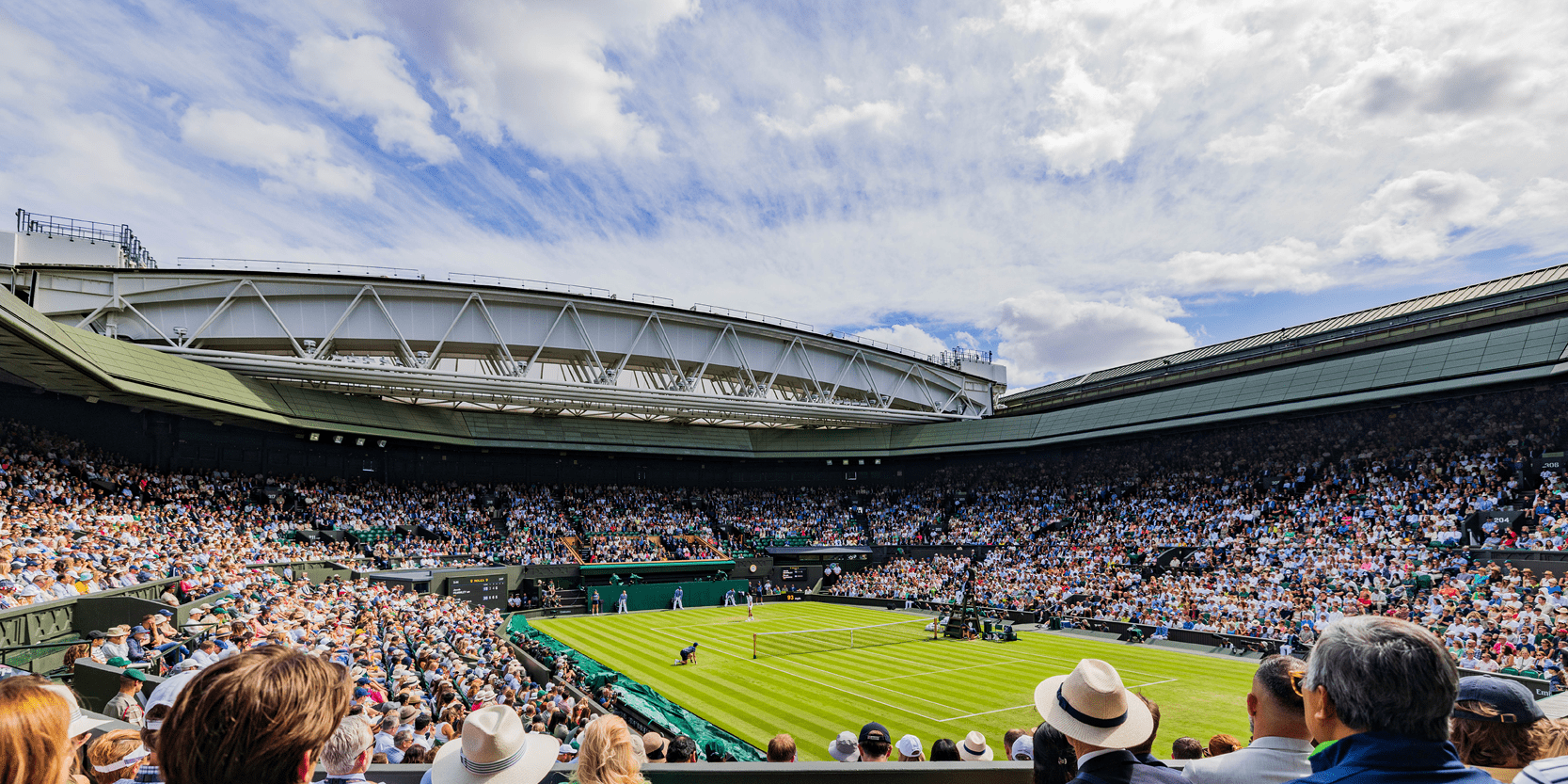View from the crowd of Centre Court at The Championships Wimbledon tennis tournament