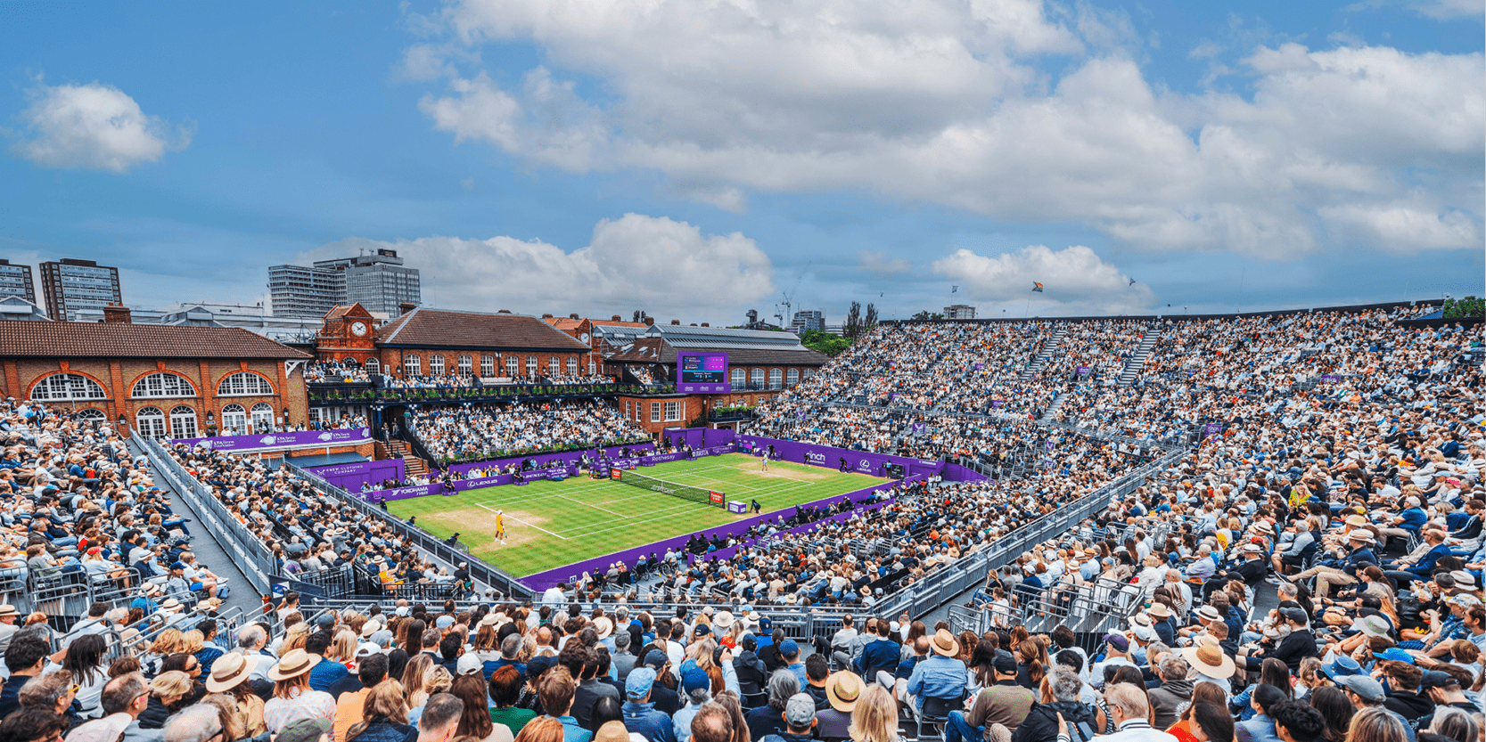 View of the club house on Centre Court amongst the crowd at The Queen's Club tennis venue for the annual ATP tournament