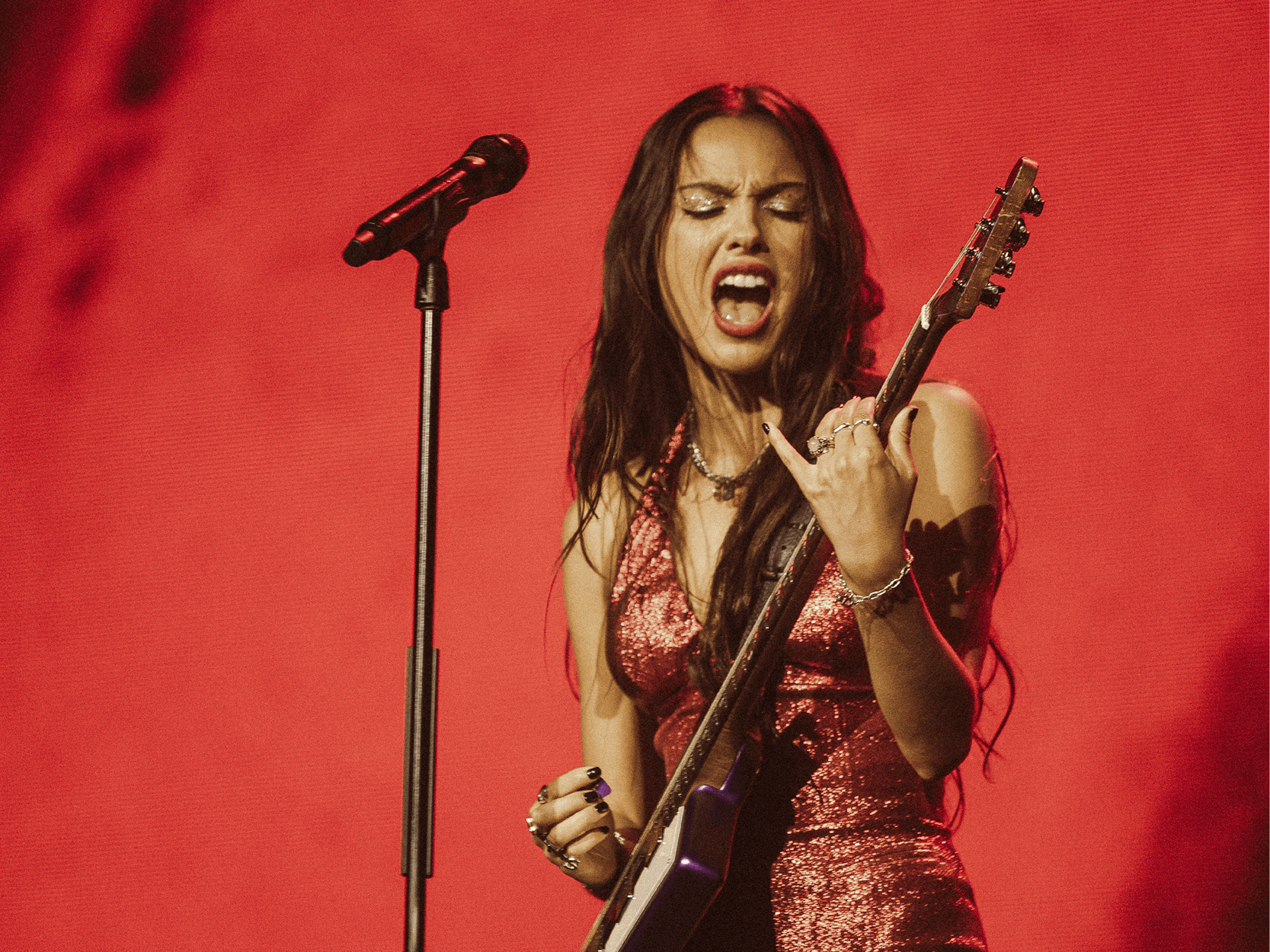 American singer Olivia Rodrigo playing guitar during a performance on stage