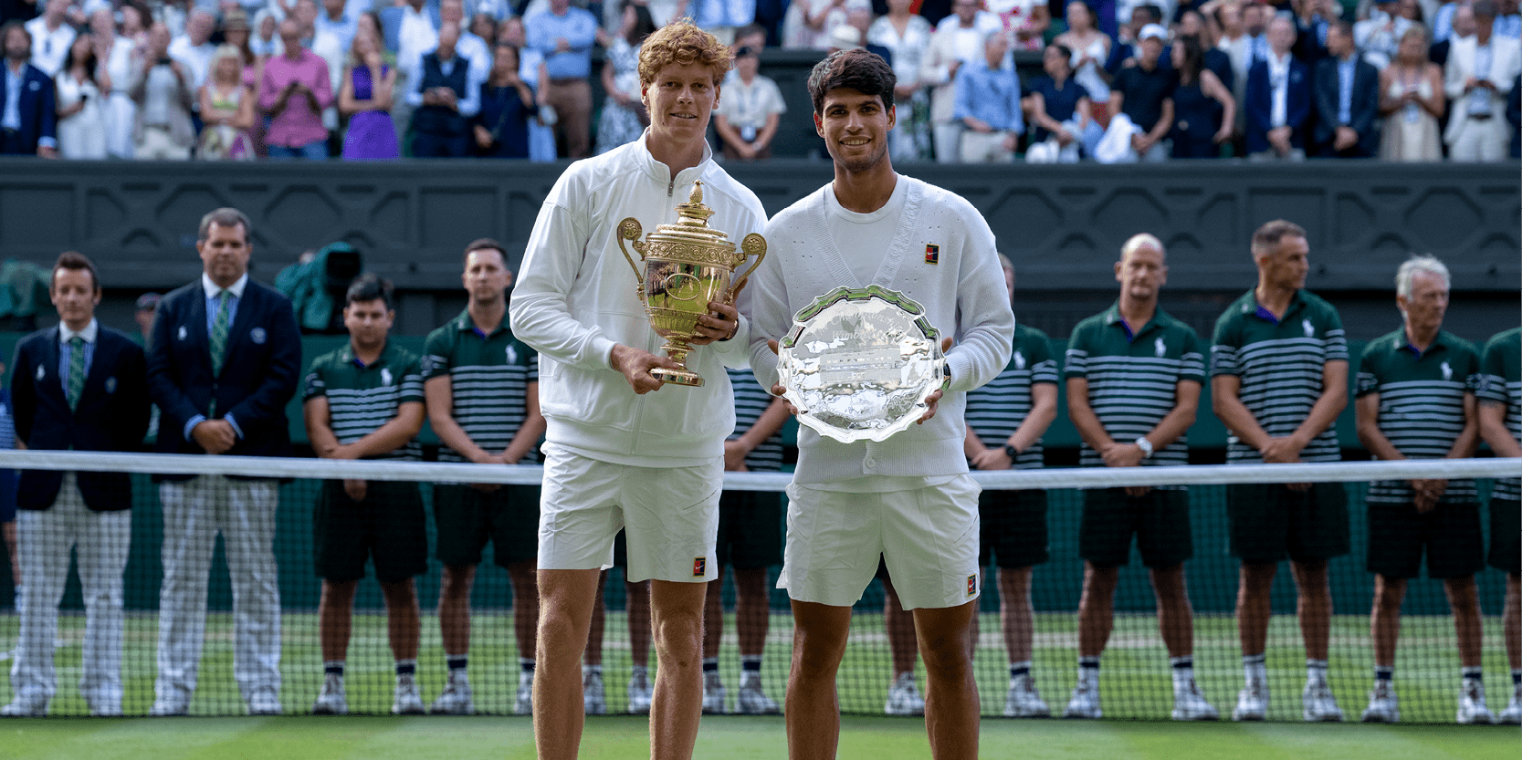 Wimbledon men's singles champion Jannik Sinner and runner up Carlos Alcaraz smiling with their trophies on Centre Court after the 2025 Wimbledon tennis Final