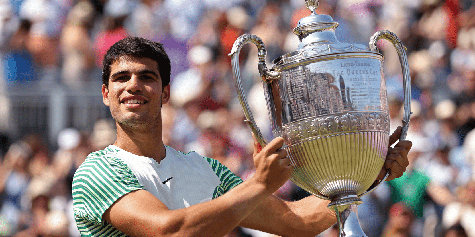 Spanish tennis player Carlos Alcaraz holding the trophy for the Queen's Club Championships in 2023 during the final
