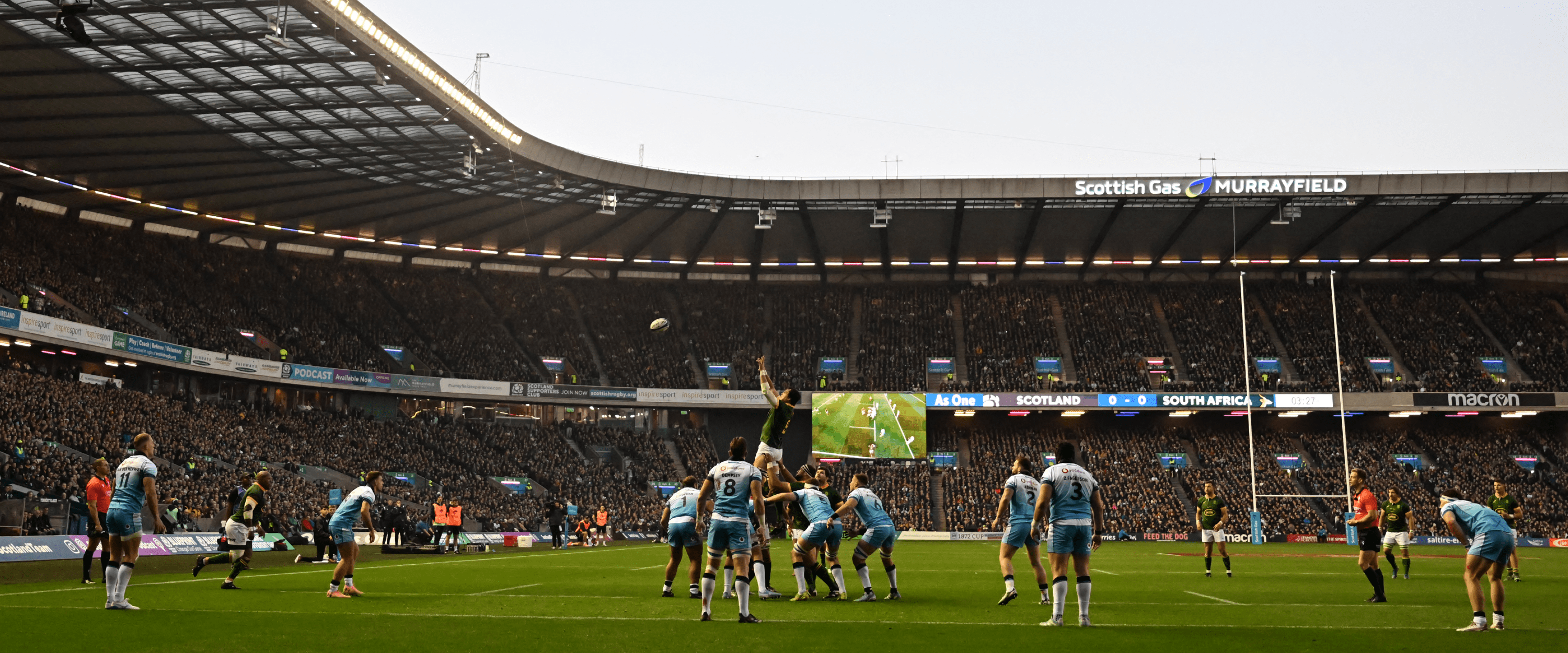 View of the Murrayfield Stadium pitch in Scotland the home ground of Scottish Rugby with rugby players warming up 