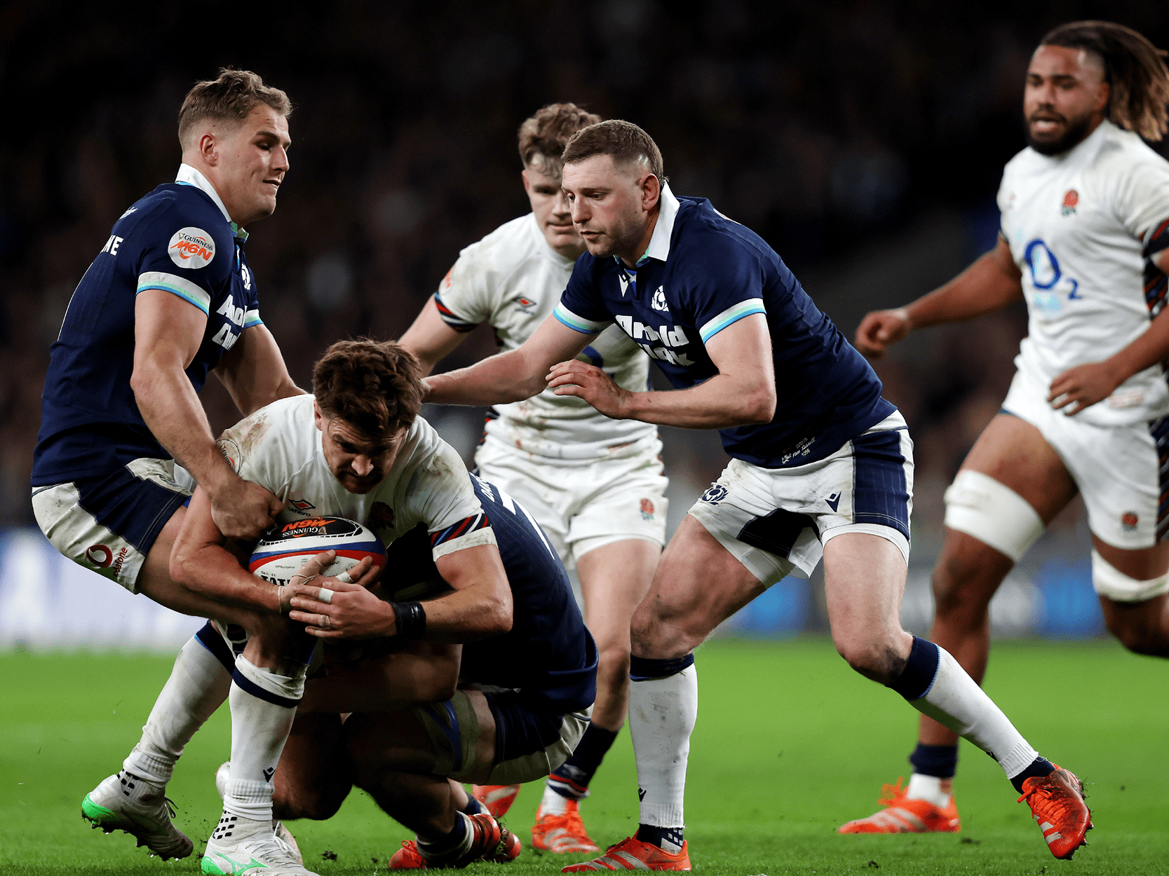 England v Scotland rugby players tackling each other during a Guinness Men's Six Nations
