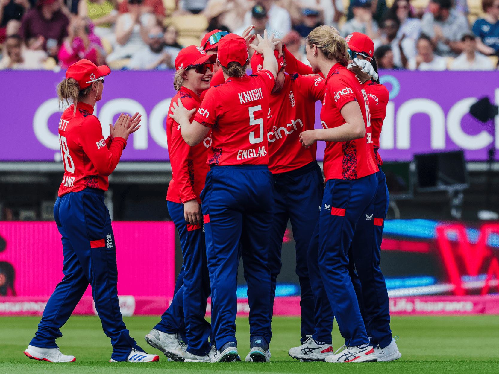 England cricket's women T20 team cheering and celebrating together during a match