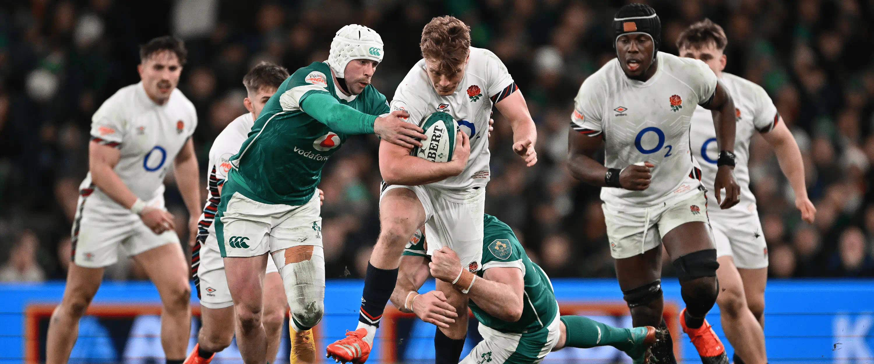 England Rugby player Fin Smith carrying the ball against Ireland in the 2025 Guinness Men's Six Nations