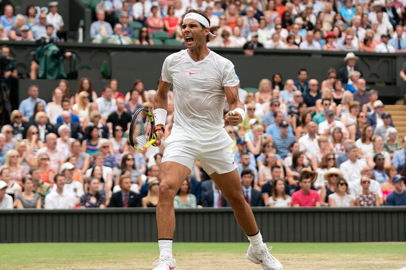 Tennis player Rafael Nadal celebrating on Centre Court at The Championships Wimbledon