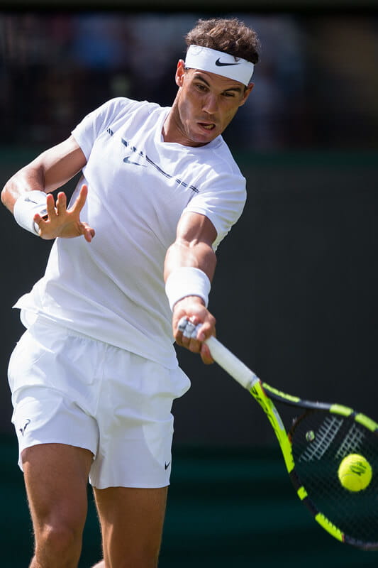 Rafael Nadal hitting the ball in a match at Wimbledon