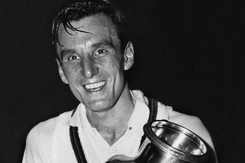 Fred Perry holding a trophy for his tennis win