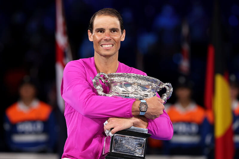 Winner of the 2022 Australian Open Rafael Nadal with the championships trophy in the Rod Laver Arena after he made history winning 21 Grand Slam titles