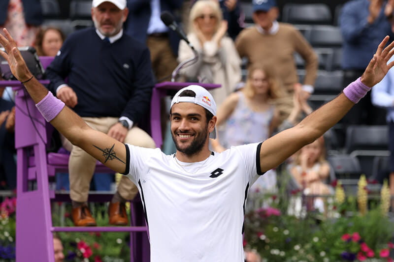 Matteo Berrettini holding his arms out after winning a match at cinch Championships at The Queen's Club in 2021