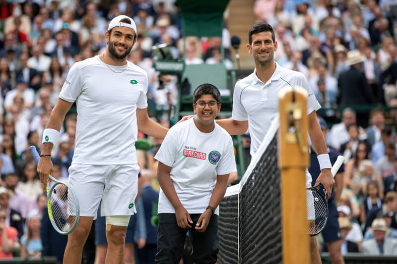 Matteo Berrettini and Novak Djokovic doing the coin toss with Wimbledon Foundation