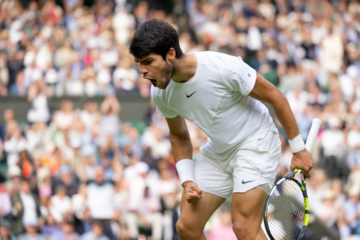 Carlos Alcaraz shouting in celebration after winning a point on centre court at Wimbledon in 2023