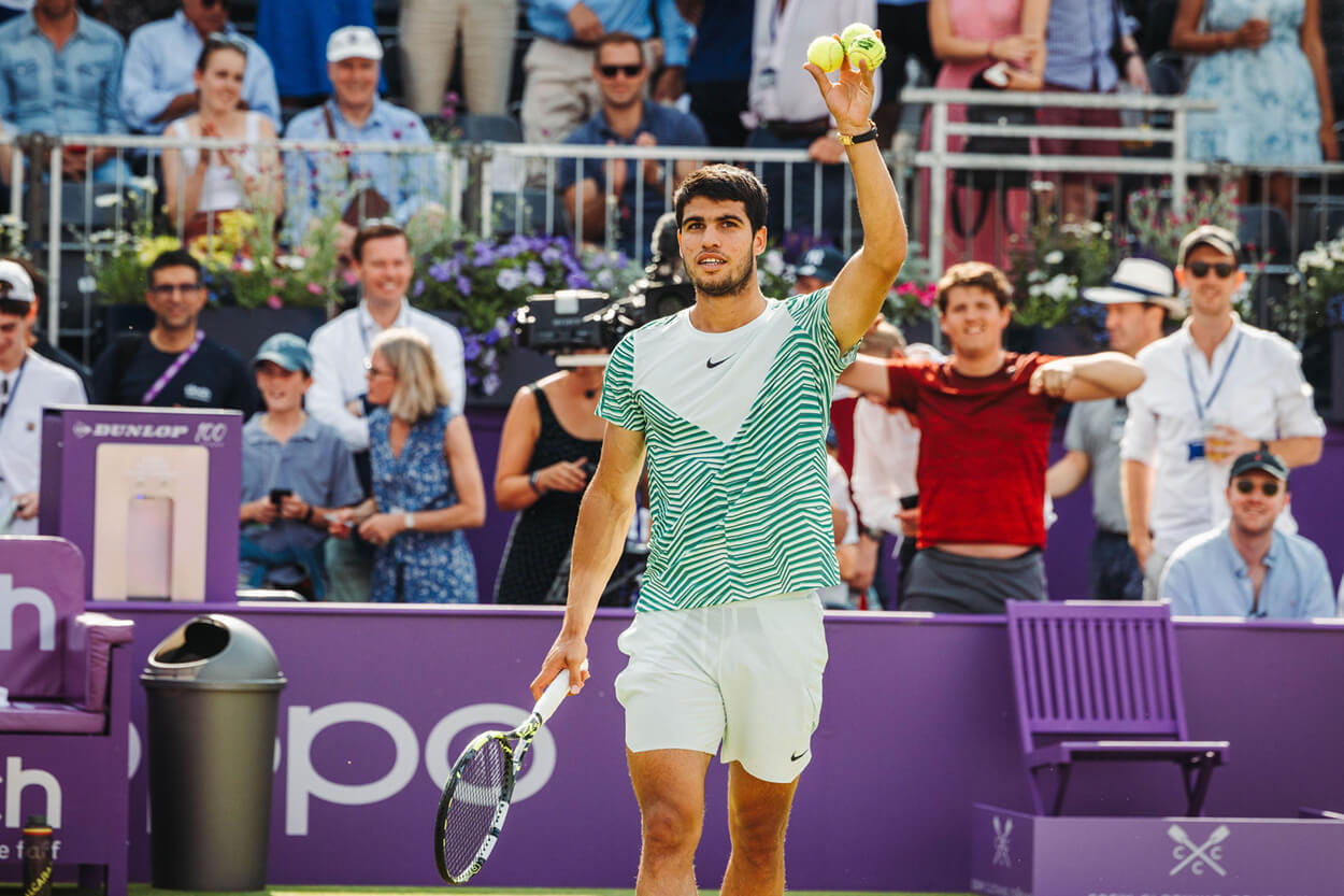 Carlos Alcaraz hitting tennis balls into the crowd after winning the cinch Championships 2023 title