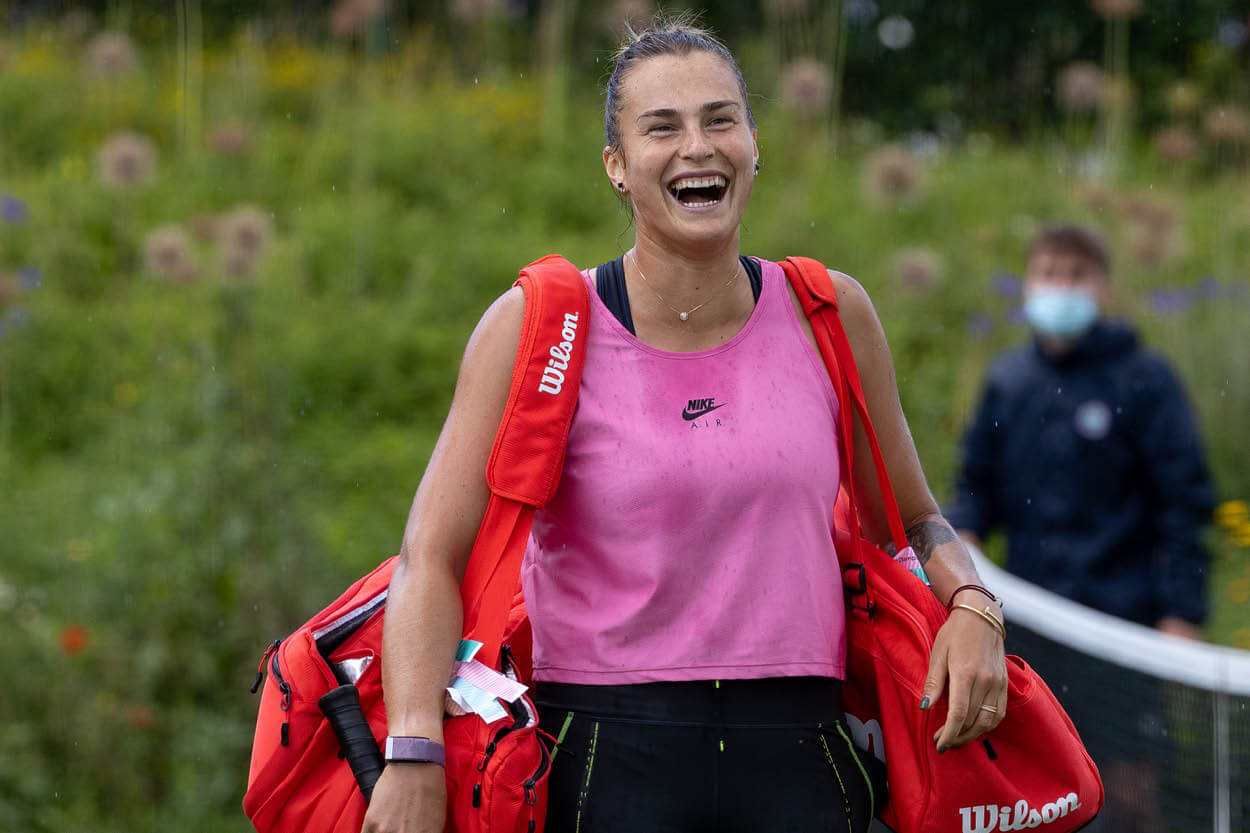 World number two Arya Sabalenka at training at Wimbledon 2023 laughing in the rain
