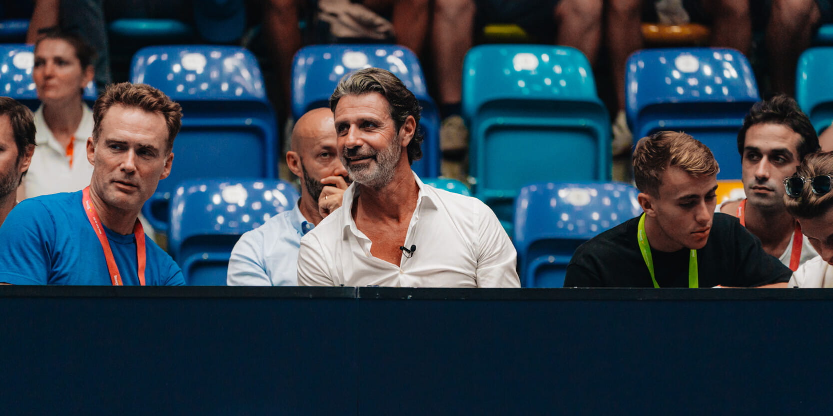 Founder of UTS tennis tournament and tennis coach Patrick Mouratoglou sitting court-side at UTS