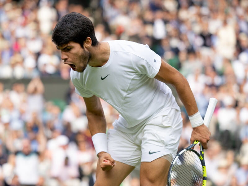 Carlos Alcaraz celebrating a win at Wimbledon