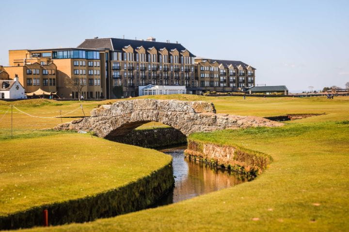 The Swilcan Bridge on The Old Course in St Andrews on a sunny afternoon.