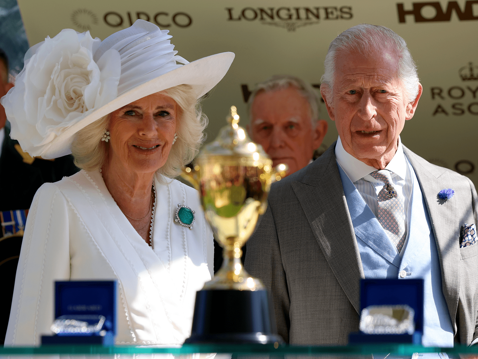 King Charles and Queen Camilla smiling with the Gold Cup trophy at Royal Ascot