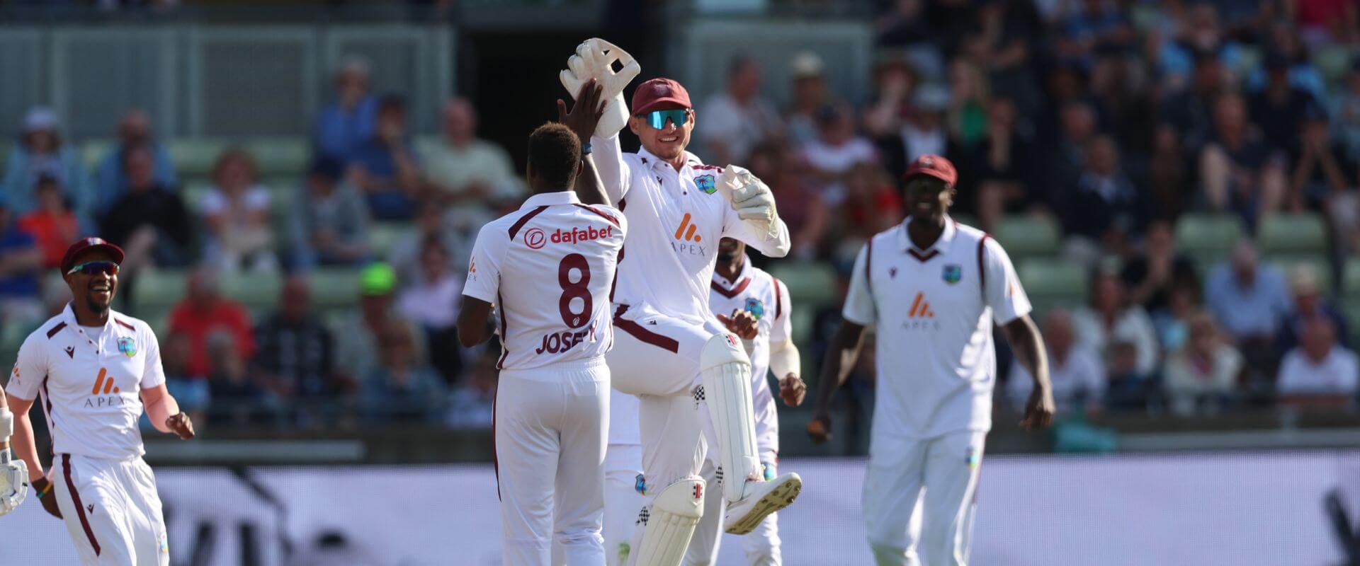 The West Indies cricket team celebrate a wicket
