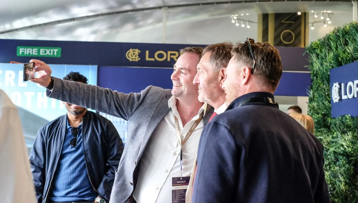 Cricket legends taking photos with guests