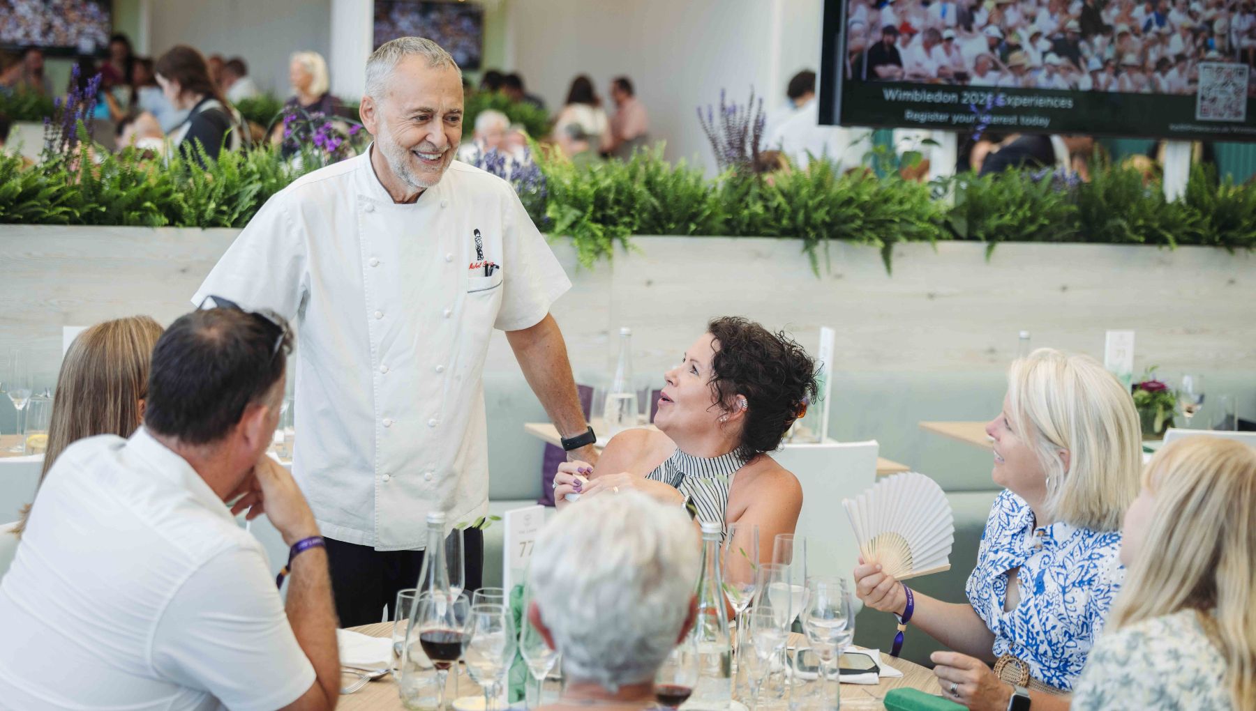 Michel Roux chatting to guests enjoying lunch at The Lawn at Wimbledon