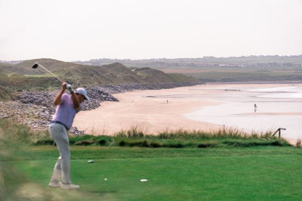 Guest playing golf with breath taking views