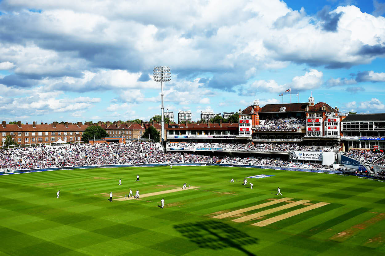 View of the Kia Oval cricket ground and pavilion with England team playing on the pitch